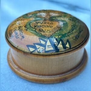 small, vintage-style wooden box with a decorative lid.